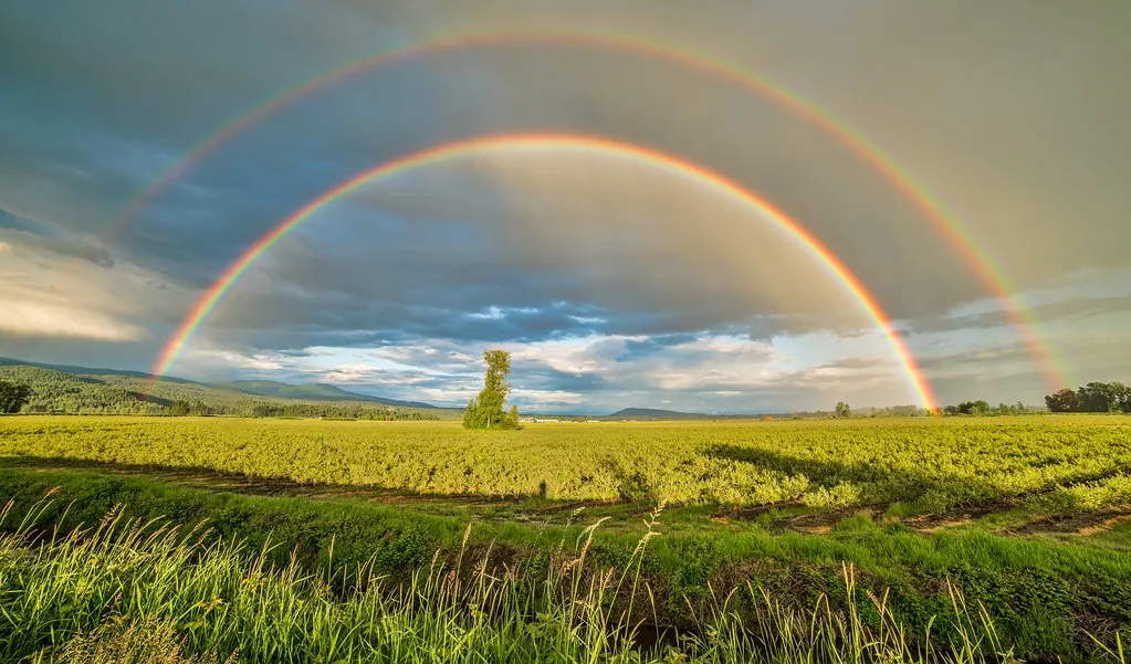 A double rainbow over a landscape